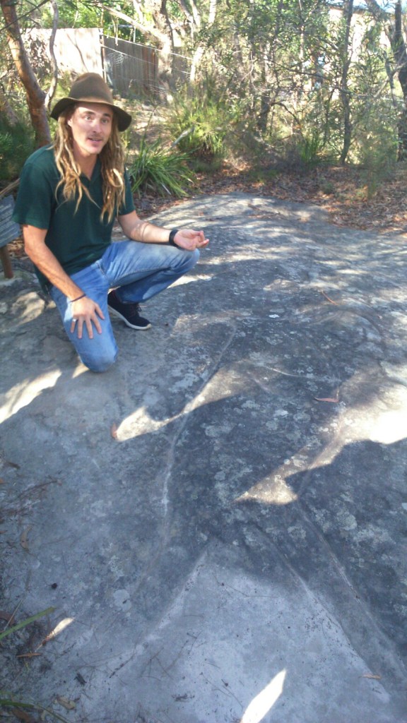 Our guide Dave shows an Aboriginal rock carving in the Blue Mountains. 